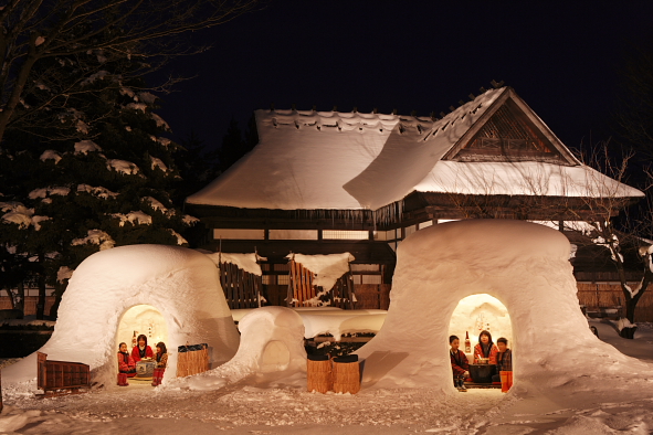 ▲雪屋中透出的溫暖燈光，搭上後方古色古香的建築，彷彿童話世界一樣。　圖：秋田縣觀光連盟／提供