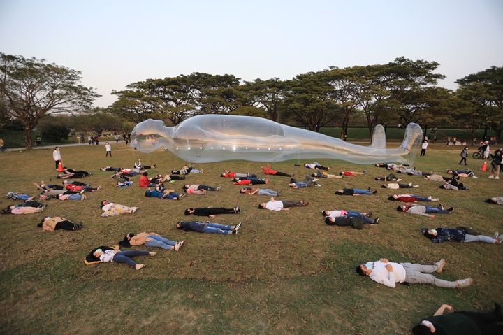 ▲跟著《空氣人》躺在衛武營的療癒草地上，享受躺平樂趣。　圖：高雄市政府觀光局／提供