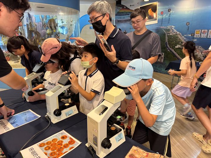 ▲家長帶著孩子用顯微鏡觀察珊瑚。　圖：新北市政府漁業及漁港事業管理處／提供